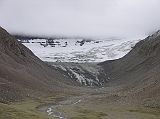 Tibet Kailash 09 Kora 01 Glacier between Avalokiteshvara and Manjushri We crossed the Dlma Chu by a bridge, and soon saw the north side of Shama Ri, east of Kailash, coming into cloudy view. This sharp jagged ridge represents the 18 Hells: 8 Cold, 8 Hot, and 2 Trial Hells. Its treacherous appearance serves as a sober reminder to pilgrims that hell exists and perhaps looks like this. A short truncated glacier with a small but distinct terminal, lateral, and medial moraines descends from the rocky eastern arm of the north face of Kailash, down through the Plung Valley between Avalokiteshvara and Manjushri.